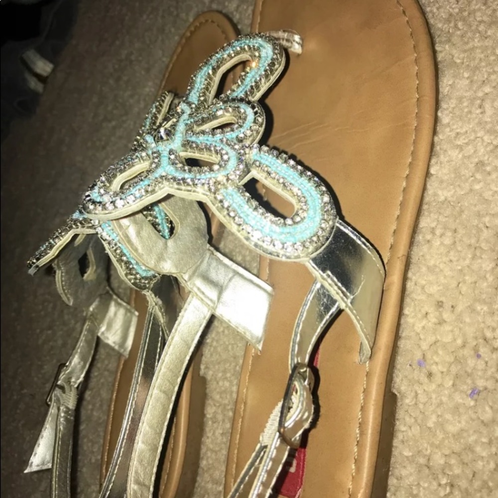 Blue jeweled sandals.